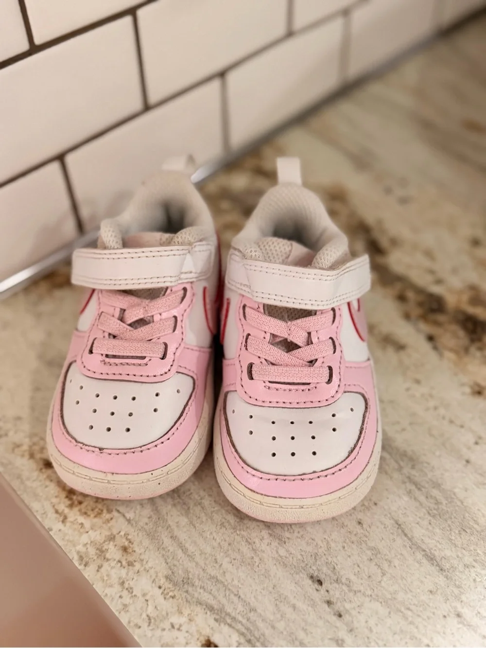 Kids Pink and White Nike shoes